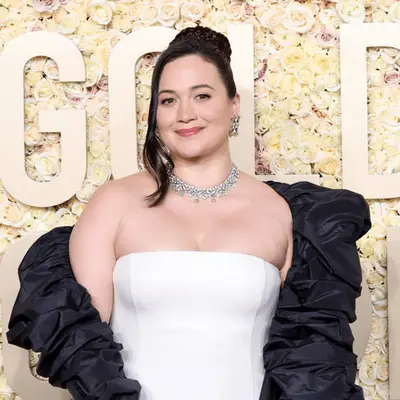 lily gladstone in white dress and updo