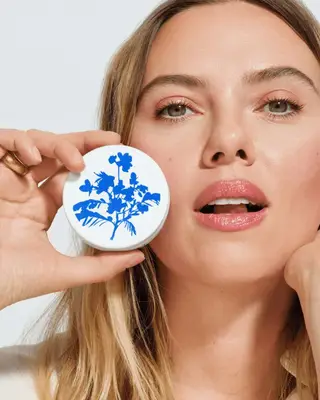 Scarlett Johansson holding skincare