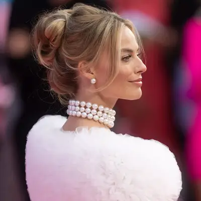 Margot Robbie with a barbie themed princess updo hairstyle