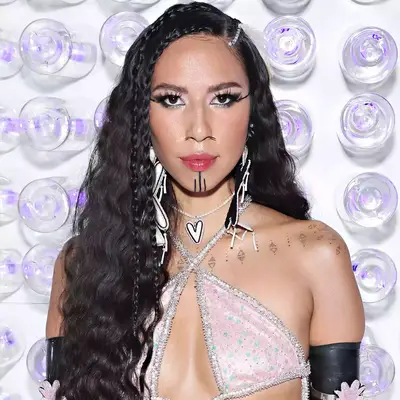 Quannah Chasinghorse with braids and feathers in her hair