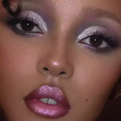 FKA Twigs with shimmering eye makeup and chrome pink lips
