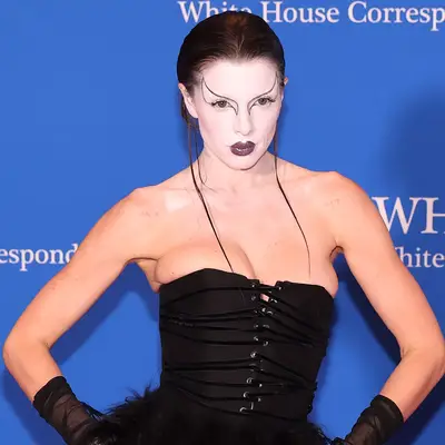 Julia Fox with black swan makeup consisting of a white painted face and abstract eyeliner
