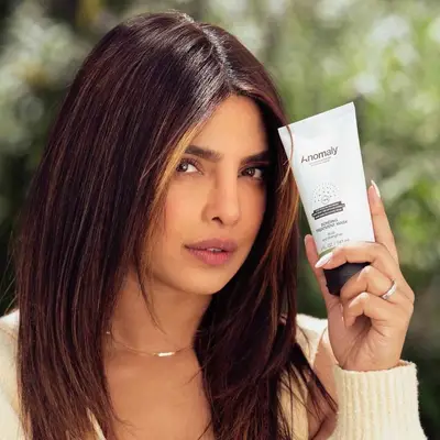 Priyanka Chopra-Jonas holding the bonding treatment mask from her haircare brand, Anomaly.