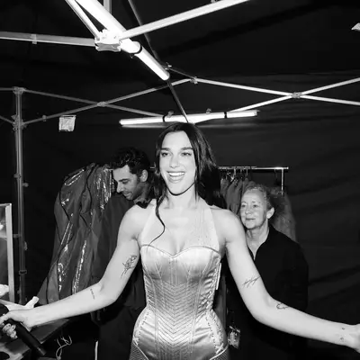 Dua Lipa backstage at a show with her flower manicure.