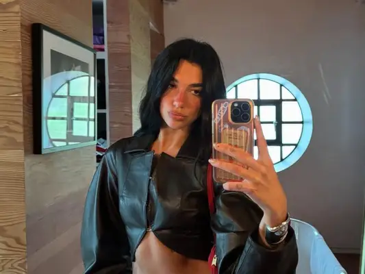 Dua Lipa poses in a mirror photo.