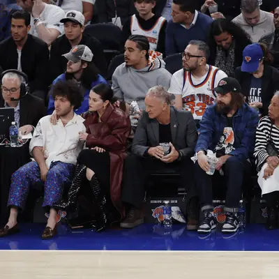 Selena Gomez and Benny Blanco sitting courtside.