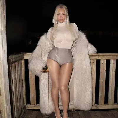 Beyonce with silver blonde hair, sequin Prada hot pants, and creamy rose lip gloss nails