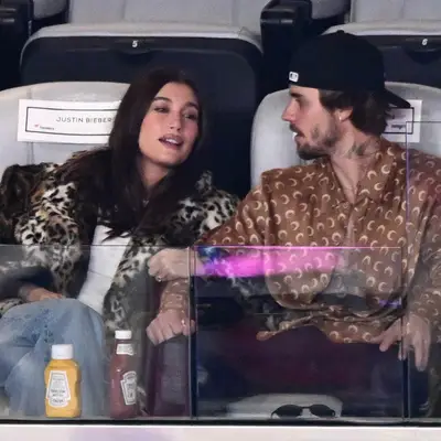 Hailey Bieber sitting next to Justin Bieber at the Super Bowl with brand new dark chocolate brown hair