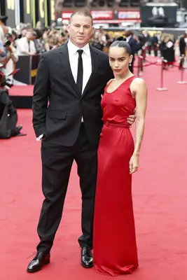 Channing Tatum in a suit and Zoe Kravitz in a red dress