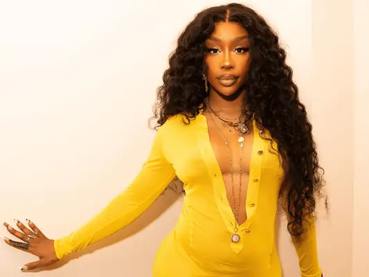 SZA wearing a yellow dress