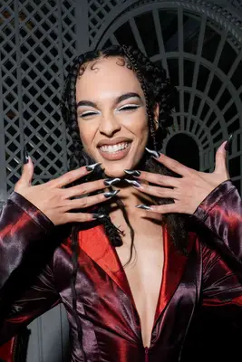 a chrome manicure topped with gemstones