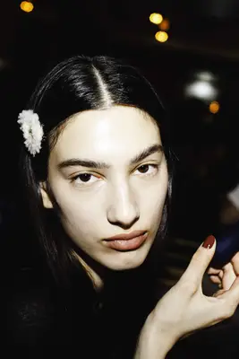 Model with long black hair and dewy shiny skin