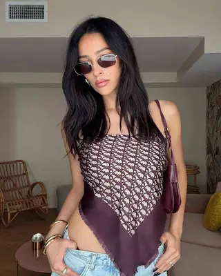 actor shay mitchell wearing sunglasses and a handkerchief top in a selfie