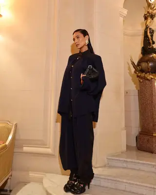 shay mitchell with sleek hair in a chic oversized outfit