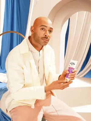 Sir John holding Gold Bond lotion