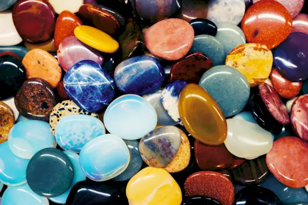 Background made of many different multi colored minerals and crystals in flat lay style