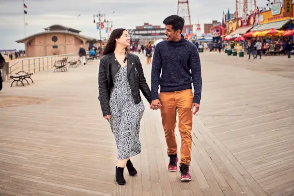 Couple walking on boardwalk at amusement park