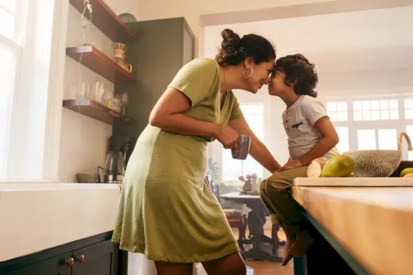 Affectionate mother touching noses with her young son
