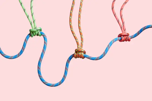 Four coloured ropes supporting a larger rope
