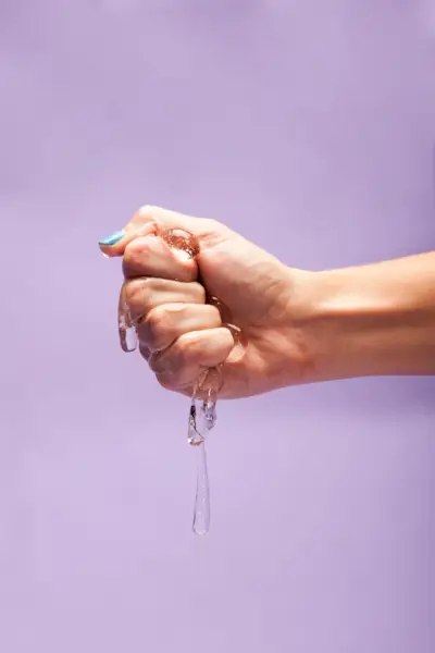 Close Up Of Women Squeezing Lube 