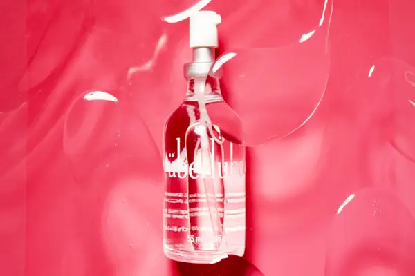 Anthurium flower with palm leaf on bright pink background. Tropical festive concept. Front view and close-up