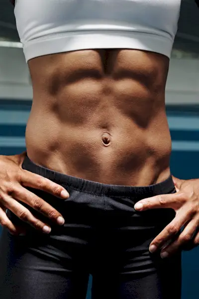 Young fit woman doing abs workout in the gym