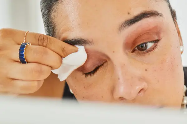 A person wiping their eyelid with Mary Kay Oil-Free Eye Makeup Remover