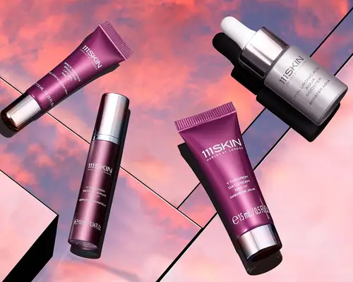 An assortment of 111Skin skincare products we recommend displayed side-by-side on iridescent tiles