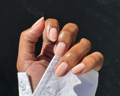 Close up of a hand with neutral polish and manicured cuticles
