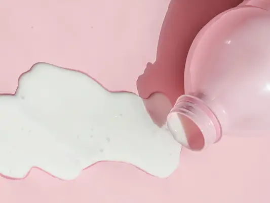 spilled milk on a pink background
