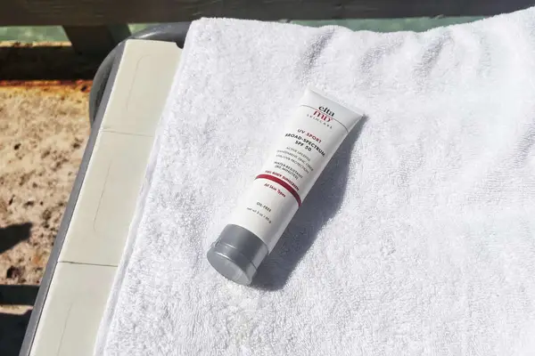 EltaMD UV Sport Broad-Spectrum SPF 50 Sunscreen tube on top of a towel 