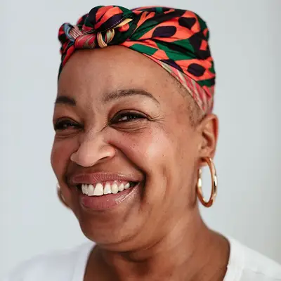 woman smiling with head wrap