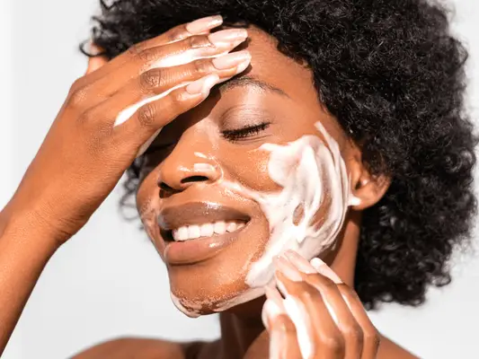 Close up of woman washing her face