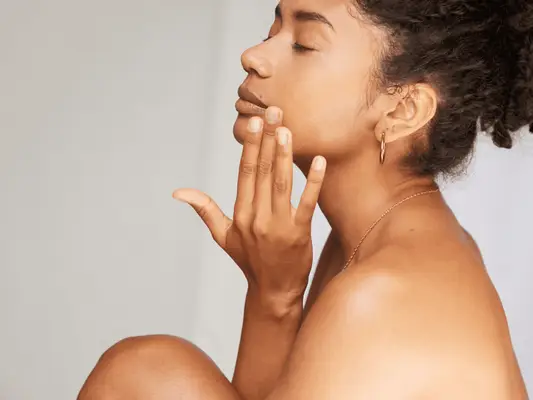 A woman touching her face with her hand
