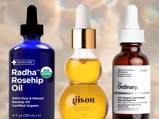 Collage of rosehip oils on a beige background, including products by Radha Beauty, Gisou, and The Ordinary