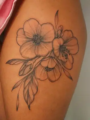 close up of black ink tattoo of pretty tropical flowers bunched together