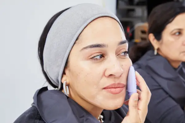 Close-up of a person using the EZBasics Facial Cleansing Brush on their cheek