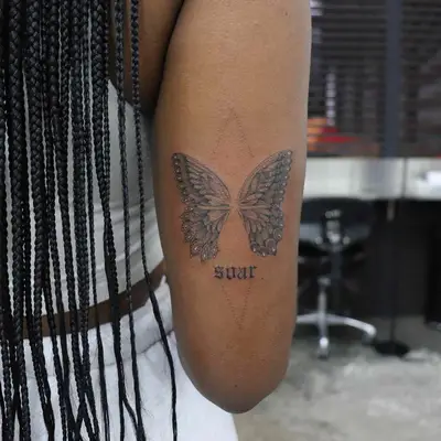Butterfly tattoo with word 