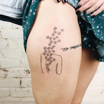 Upside down word tattoo on upper thigh