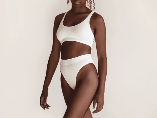 A woman in a white bra and matching underwear 