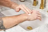 person applying Le Labo Santal 33 Body Lotion to their hand