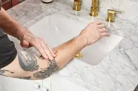 person applying Le Labo Santal 33 Body Lotion to their arm