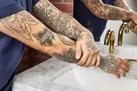 person applying Bevel Body Lotion to their arm