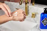 person applying Jack Black Cool Moisture Body Lotion to their hands