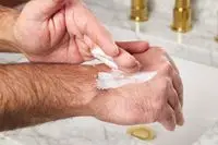 person applying Hempz Original Herbal Moisturizing Body Lotion to their hand