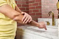 person applying Hempz Original Herbal Moisturizing Body Lotion to their arm