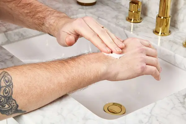 person applying Le Labo Santal 33 Body Lotion to their hand