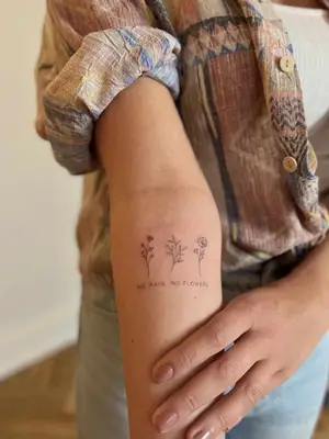 forearm with flower tattoo