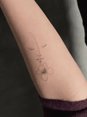 forearm with flower tattoo