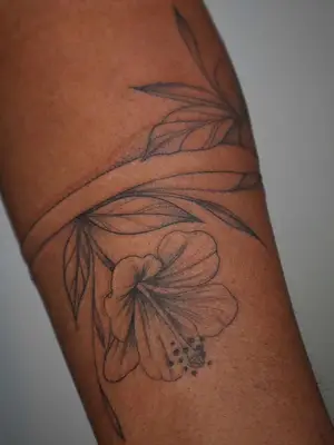 forearm with flower tattoo